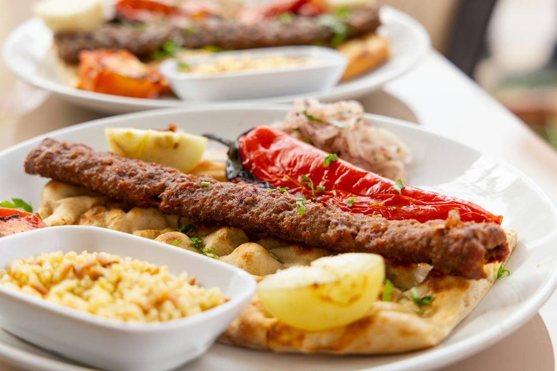 Mixed kebab platter with peppers and bulgur